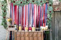 08 a drink station with a touch of boho – a colorful stripe backdrop and lush greenery plus a mid-century modern sideboard