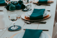 09 The wedding tablescapes were done with teal and turquoise, with large pompoms and napkins and nothing excessive