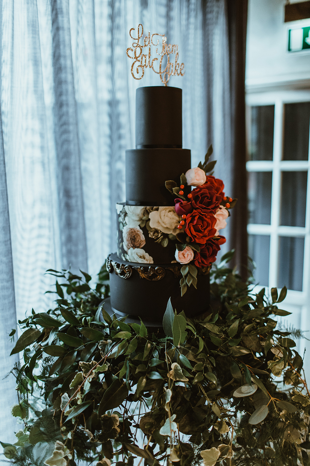 The wedding cake was a matte black one, with a floral tier and sugar and real blooms with a calligraphy topper