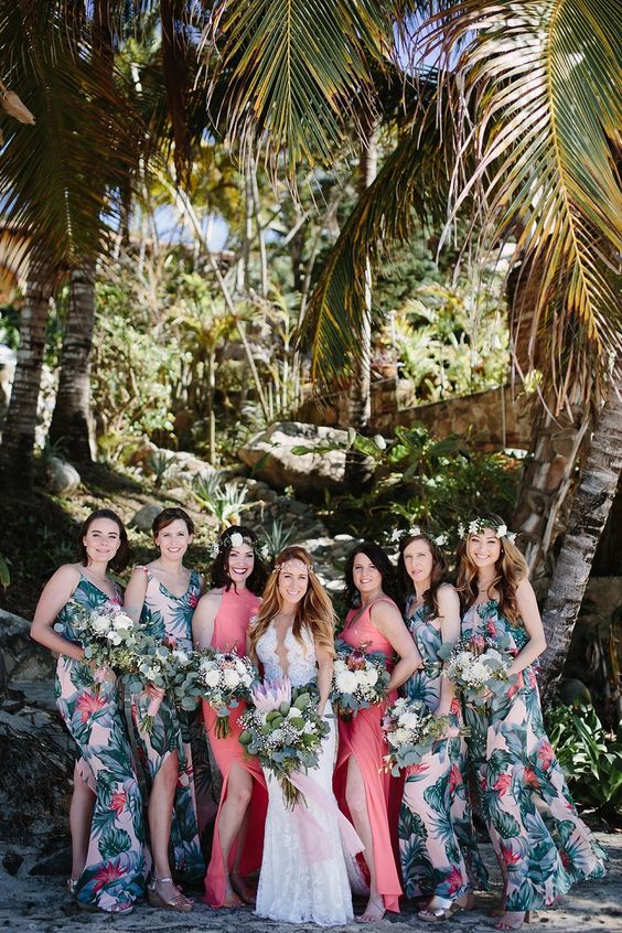 bold tropical print bridesmaids' dresses with side slits and bright coral maxi gowns with side slits for the maids of honor