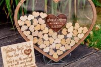 12 a transparent acrylic heart filled with smaller wooden hearts that are signed by the guests is a cool idea