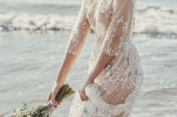 14 a sheer wedding gown with floral embroidery, a high neckline and long sleeves for beach bride