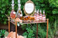 14 an elegant drink cart with large paper blooms and a chic gold framed sign for a backyard garden shower