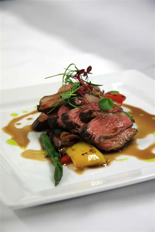 chargrilled lamb with fresh sprign veggies and herbs on top is a cool idea for a spring wedding