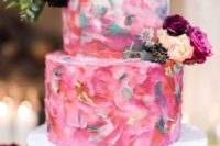 16 a colorful brushstroke wedding cake in pink and grey, with fresh blooms and berries on top