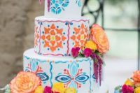 17 a super bright Mexican-inspired wedding cake with lots of colors and patterns plus fresh blooms