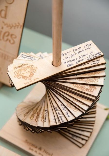 a copper stand with lots of wooden planks with burnt hearts and wishes from your guests