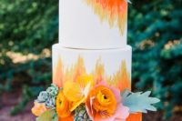 19 a colorful wedding cake with ombre orange and yellow patterns, succulents and fresh blooms
