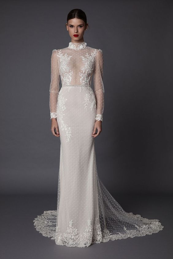 a super sexy sheath wedding dress with a turtleneck, long illusion sleeves and a sheer bodice with lace