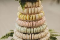 22 a macaron tower with creamy, blush, yellow and mint macarons plus fresh yellow blooms on top