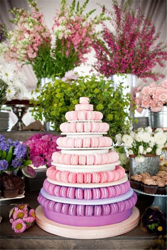 a large ombre macaron tower from pink to purple is a hot idea for a modern wedding