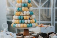 26 a colorful macaron and heart-shaped cookie tower with fresh blooms for decor