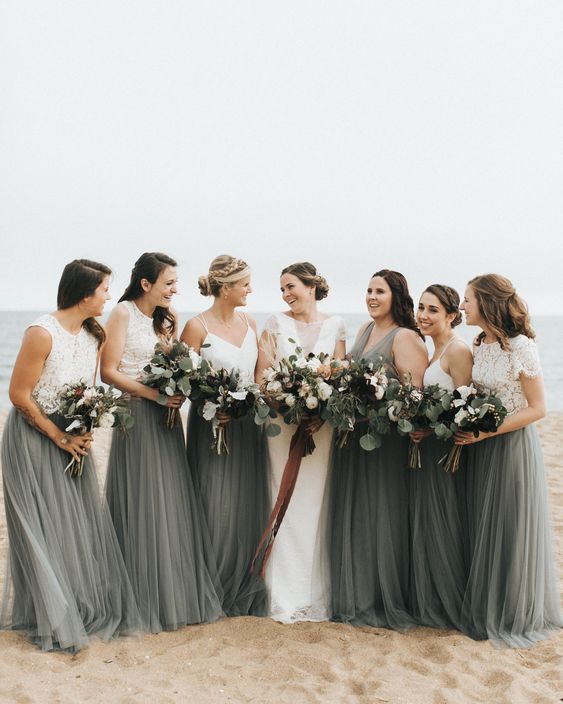 white lace crop tops and dark green maxi skirts for the bridesmaids and a dark green maxi gown for the maid of honor