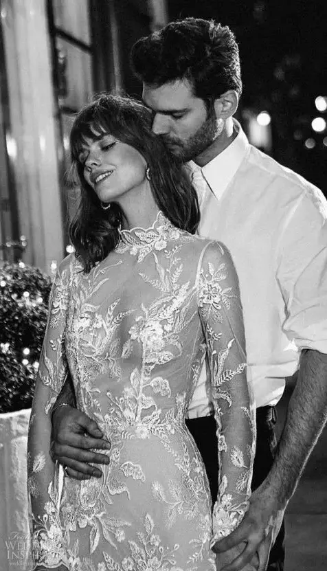 a beautiful wedding dress with a sheer bodice with strategically placed lace and long sleeves plus a non-sheer lace skirt