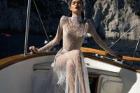 a fully naked wedding dress with embroidery, long sleeves and a high neckline plus a train is amazing