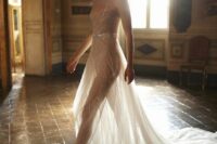 a gorgeous sheer naked wedding dress with spaghetti straps, fully embellished and with a train plus a gold belt is wow