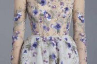 a jaw-dropping wedding dress with a sheer bodice done with delicate purple embroidery that is strategically placed and a matching but not sheer skirt