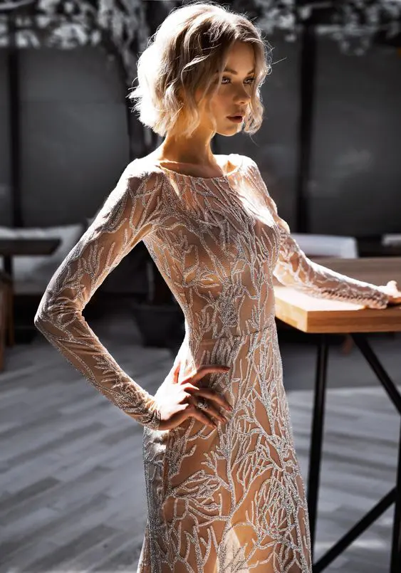 a naked fitting wedding dress with silver embroidery that covers the whole dress is a unique and bold idea for a modern wedding