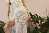 a pretty naked wedding dress with a sheer skirt covered with lace applique completely, with a high neckline and short sleeves plus a train