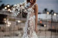 a sexy semi-sheer mermaid wedding dress with floral appliques all over the dress, a train and thick straps plus a deep neckline