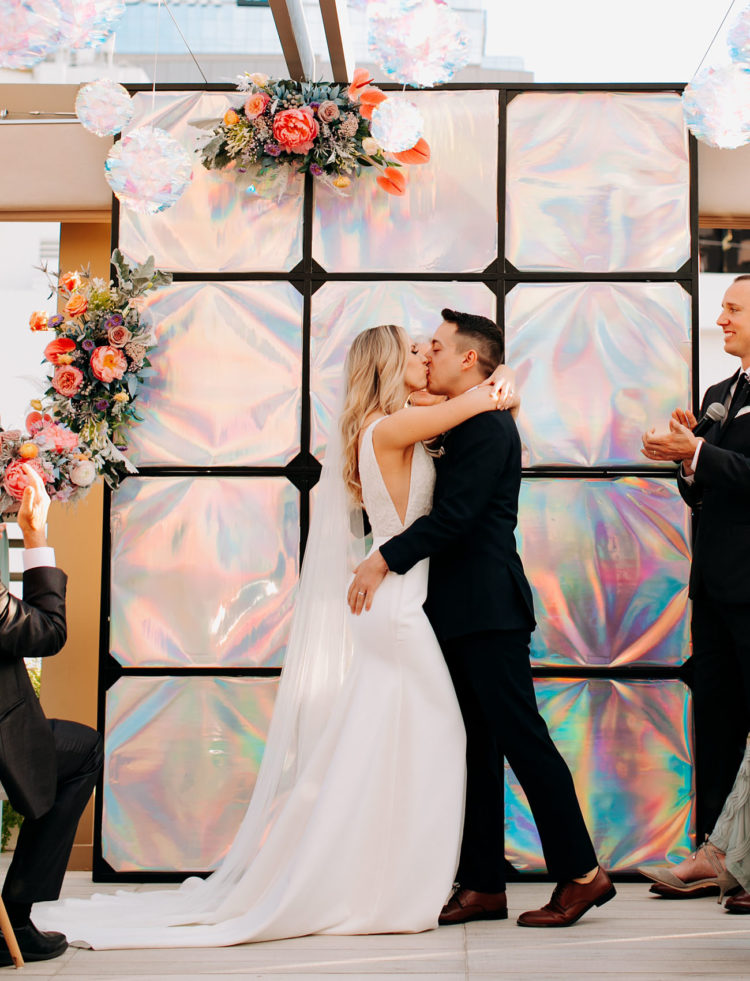 This couple went for an eclectic wedding with iridescent touches and bright colors plus some cat touches