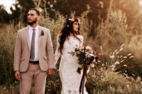 02 The bride was wearing an ivory lace mermaid wedding dress with a high neckline and long sleeves, the groom was wearing a tan suit with a floral tie