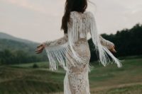 02 a boho lace sheath wedding dress with long sleeves and long fringe that makes the gown look super trendy