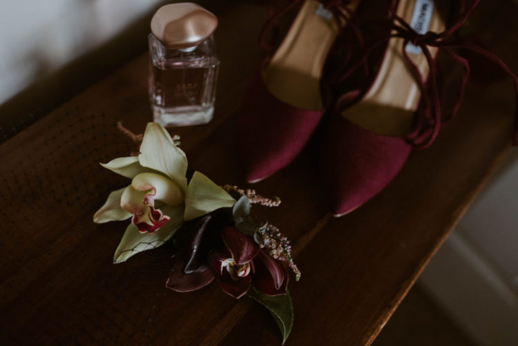 Her shoes were burgundy to match the blooms and her lipstick