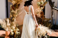 03 The bride was wearing a textural A-line wedding dress with a plunging neckline and a cutout back