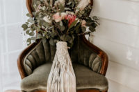 03 The wedding bouquet was a lush arrangement with waxflowers, roses, king proteas, eucalyptus and a macrame wrap