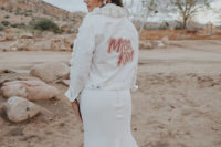 04 The bride was wearing a white denim jacket with pompoms and a painted back