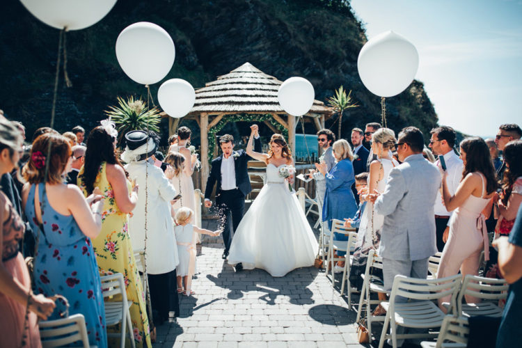 The ceremony space was done with a minimal arch of baby's breath and giant white balloons to mark the aisle
