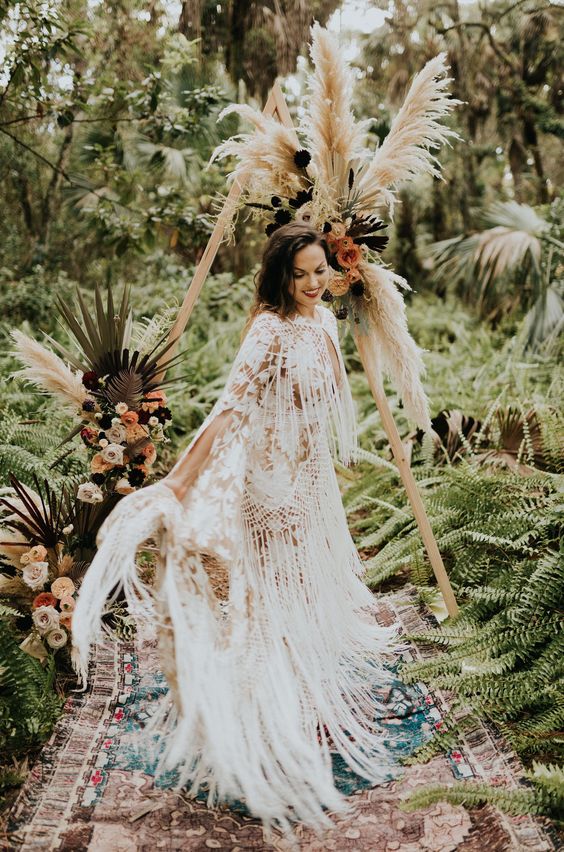 a boho lace sheath wedding gown all covered with long fringe looks very breezy and wild