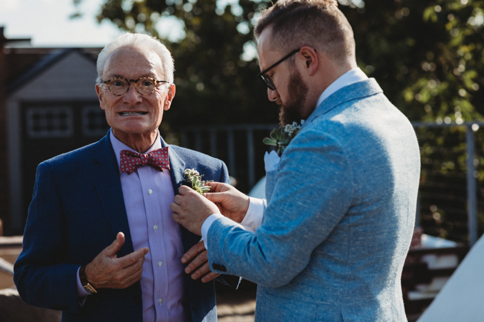 This is one of the grooms' fathers, rocking a chic succulent boutonniere, too