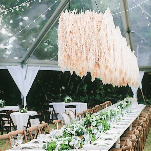 a floating pampas grass wedding installation over your reception tables will make them super trendy