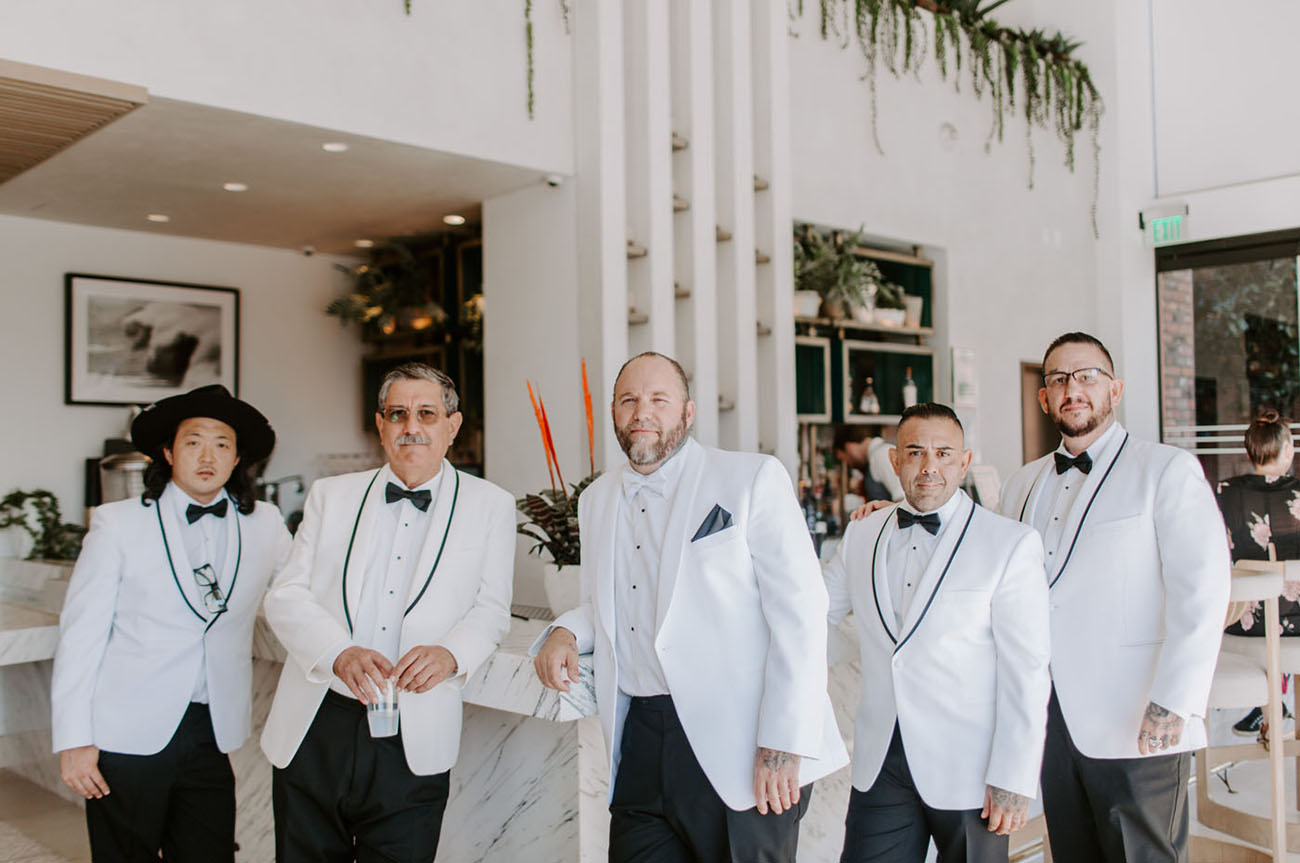 The groom and groomsmen were wearing white tuxedos