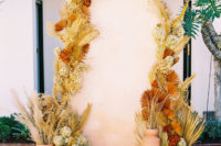 an unique dried florals wedding backdrop
