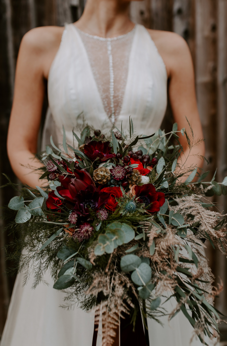 The wedding bouquet was lush and textural, with eucalyptus, thistles and lots of blooms and berries