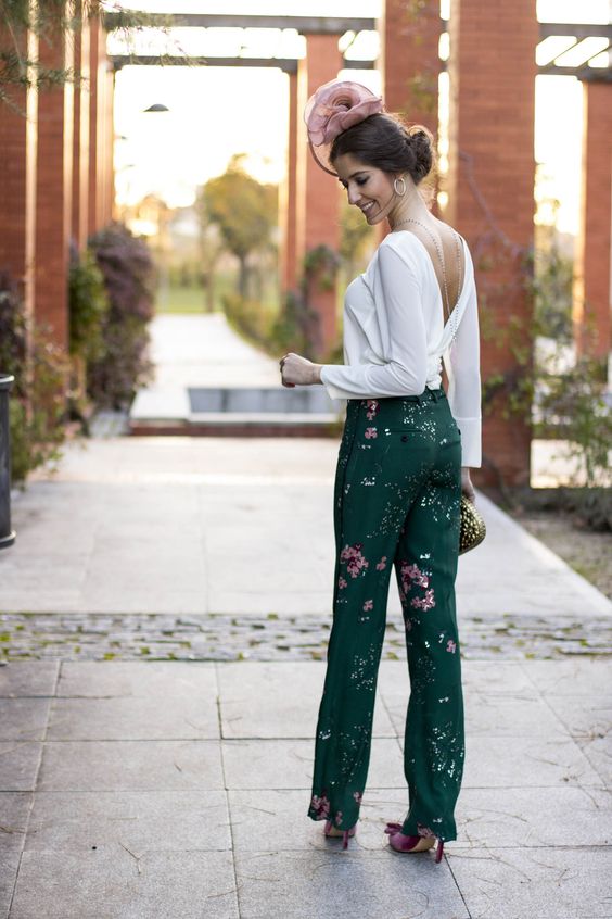 dark green floral pants, a white blouse with a cutout back, a back necklace, a metallic clutch and fuchsia shoes