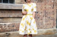 09 a floral A-line knee dress with a thin yellow belt and black heels for a refined look
