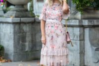 10 a knee floral embroidery dress with short sleeves and ruffles, a pink bag and burgundy lace up heels