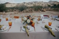 11 The wedding tablescape was done with amber glasses, green napkins and bright floral centerpieces