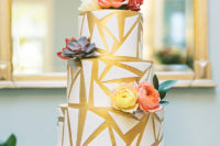 12 The wedding cake was gold and white, with geometric patterns and bright blooms and succulents