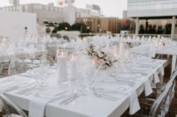 13 The reception tables were all-white, with candles, beautiful floral centerpieces, sheer chargers and white napkins