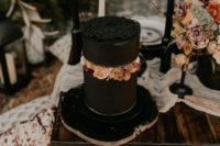 13 The wedding cake was a black one, made up of two parts and with lush bright flowers in between