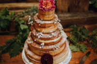 13 The wedding cake was naked, with baby’s breath, bold blooms and a cake topper