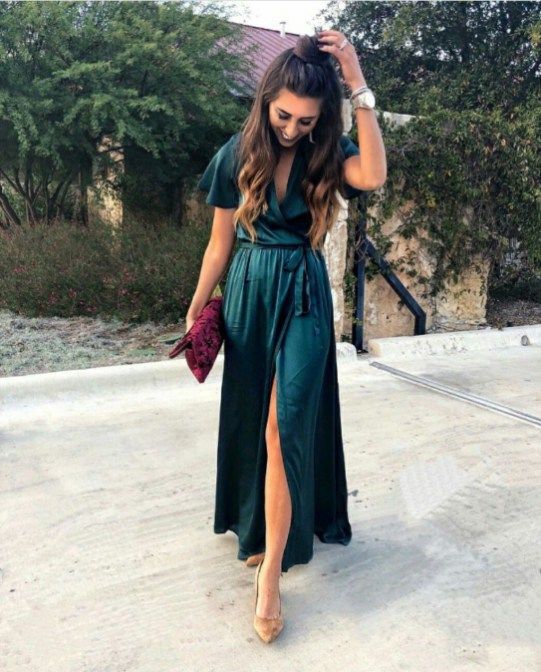 a dark green wrap maxi dress with short sleeves, nude shoes, a purple printed clutch
