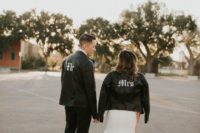 13 the groom and the bride wearing matching black leather moto jackets with handpainted details for a modern feel
