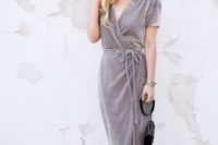 14 a grey velvet wrap maxi dress with short sleeves, a black bag and nude heels for a fall wedding