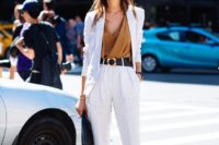16 a pure white pantsuit with an oversized blazer, teal heels, a teal bag, a camel draped top